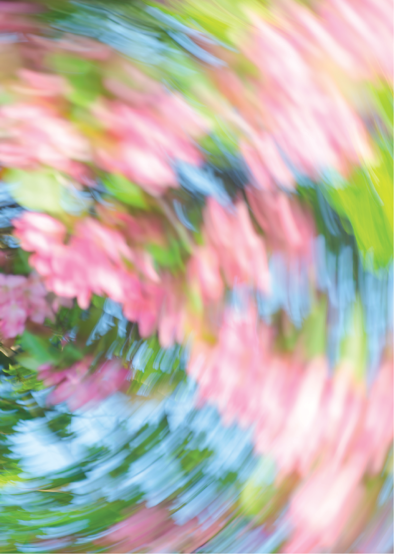 Abstract swirling pattern of pink, green, and blue colors