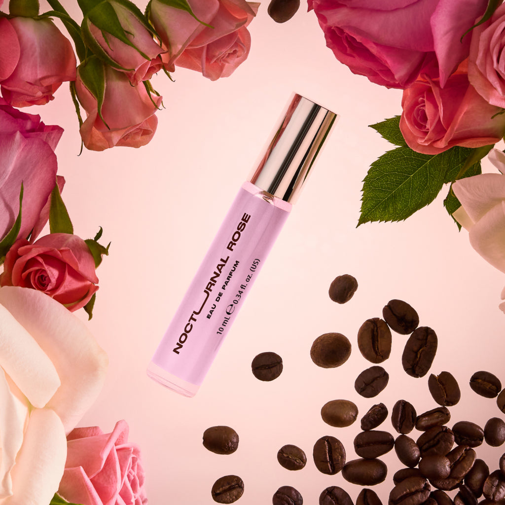DON.BEAUTY Nocturnal Rose EDP bottle with roses and coffee beans on a pink background